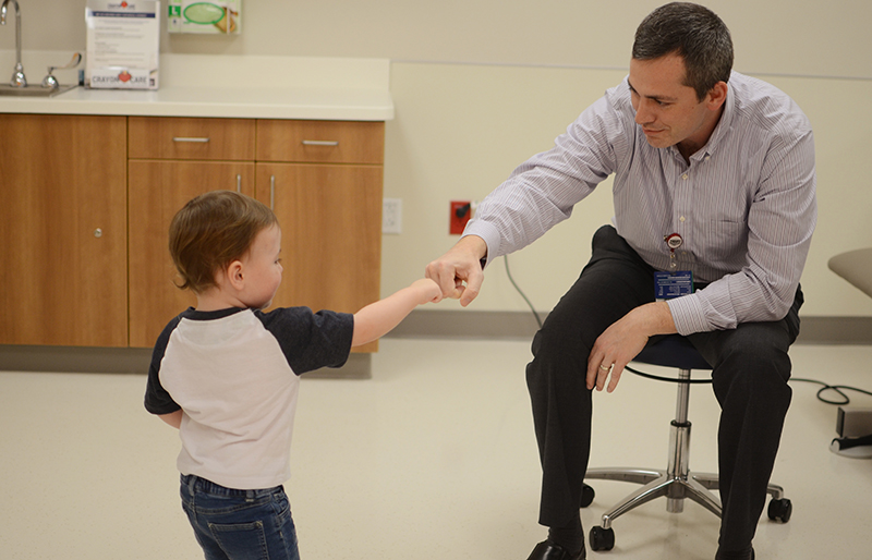 Scottish Rite pediatric orthopedic specialist with patient in exam room